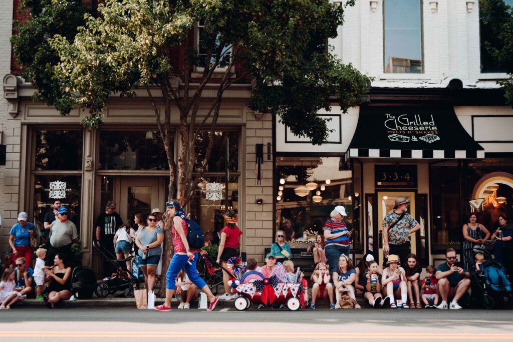 The Ultimate Summer Bucket List: Your Definitive Guide to Seasonal Fun in Franklin Crowd of people, including families with children, gathered outside a storefront on a sunny day in Williamson County, Tennessee.