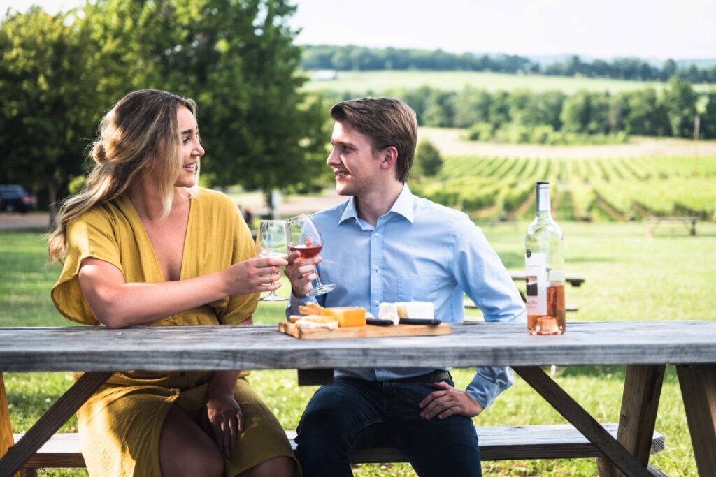 How to Make Your Next Franklin Picnic the Most Luxurious A couple enjoys wine and cheese on a picnic table overlooking a vineyard in Williamson County, Tennessee.
