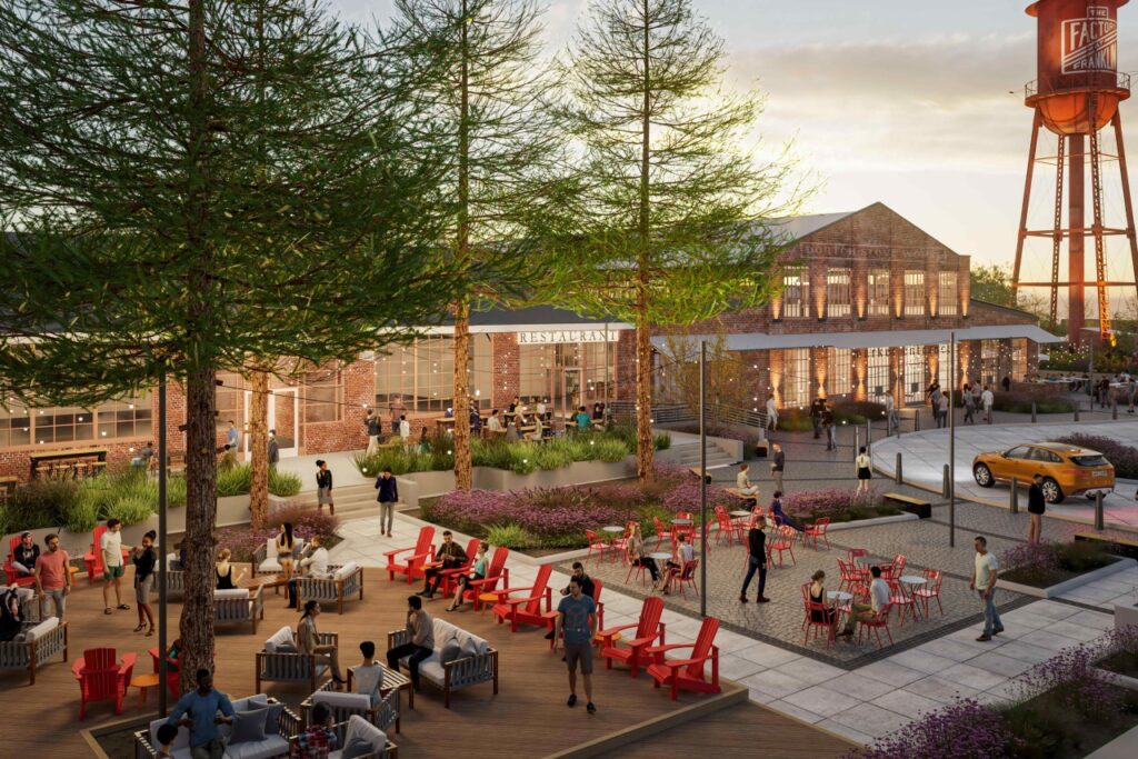 Outdoor dining area with red chairs and tables, surrounded by trees and a historic water tower in Williamson County, Tennessee.