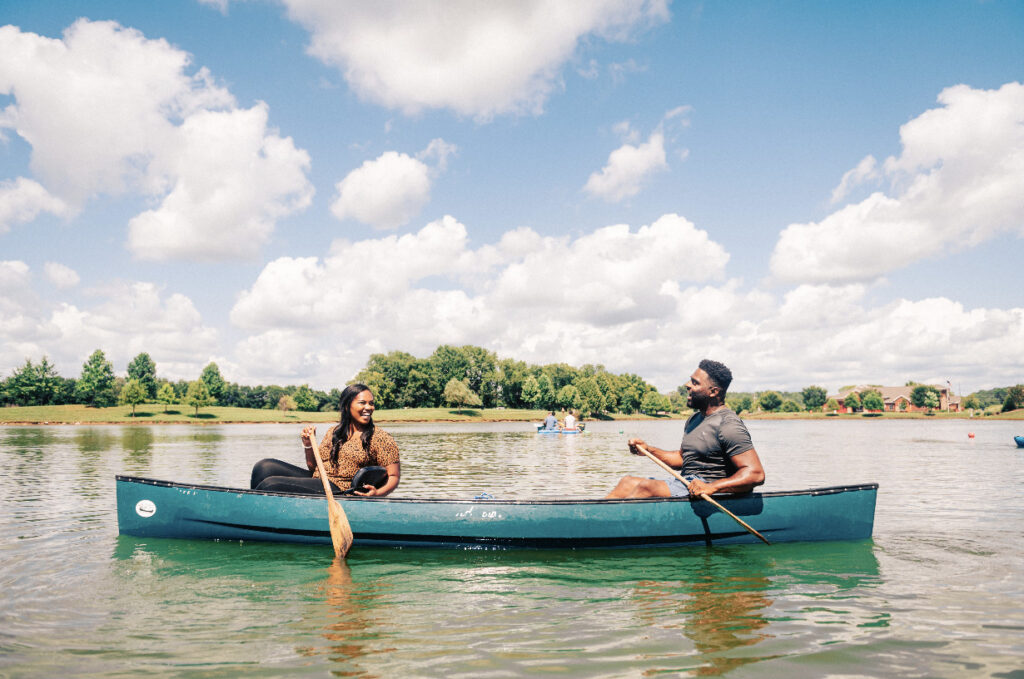 9 Perfect Pairings for a Spectacular Summer Day in Franklin Two people enjoying a peaceful canoe ride on a calm lake under a cloudy sky in Williamson County, Tennessee.