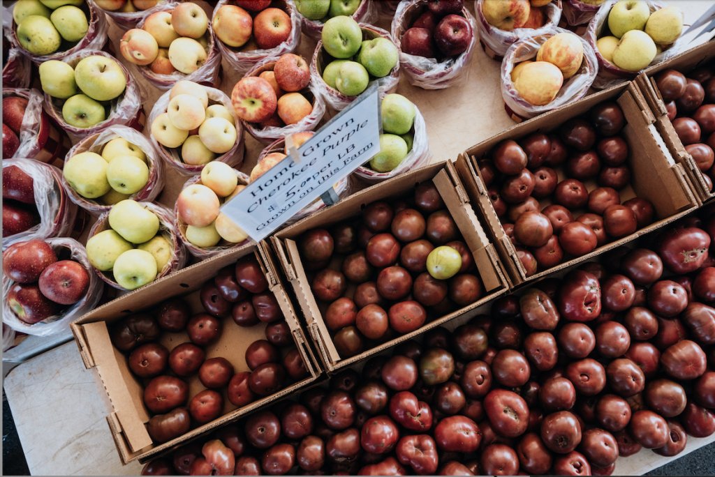A Local's Guide to Franklin's Best Farm Stands and Field-to-Table Finds A variety of apples and tomatoes are displayed in cardboard boxes at a market in Williamson County, Tennessee.