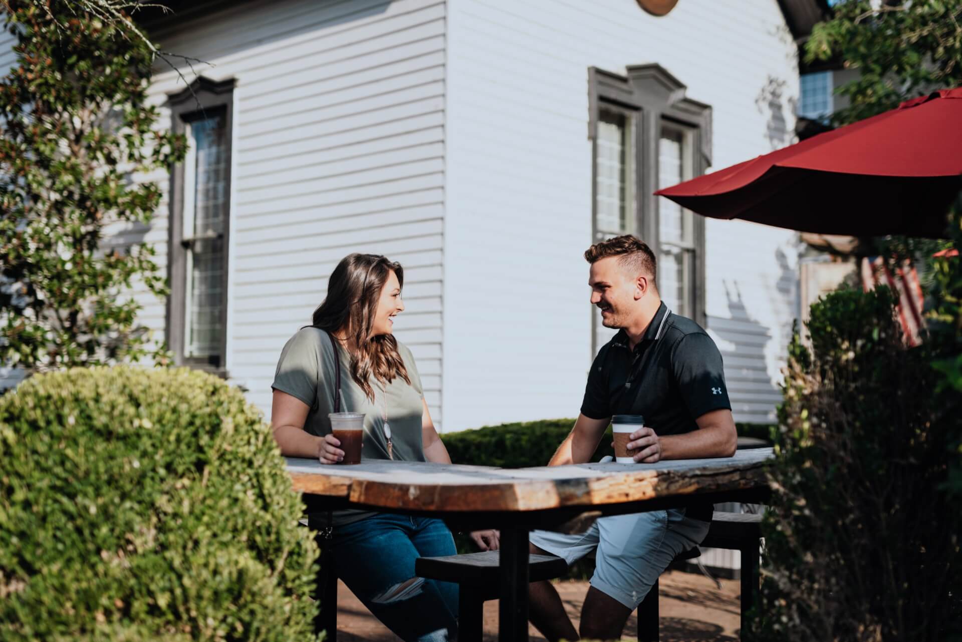 A couple enjoying coffee at a wooden table in Franklin, Tennessee. 