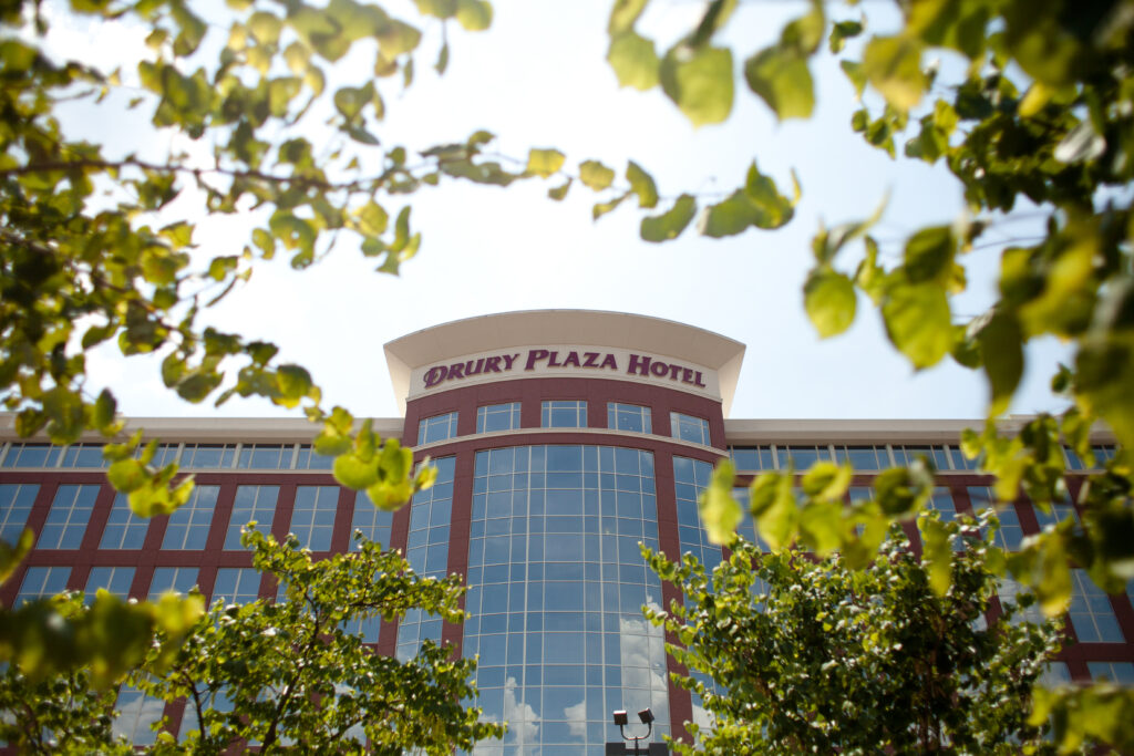 A modern hotel building with a curved glass facade and red brick accents in Williamson County, Tennessee.