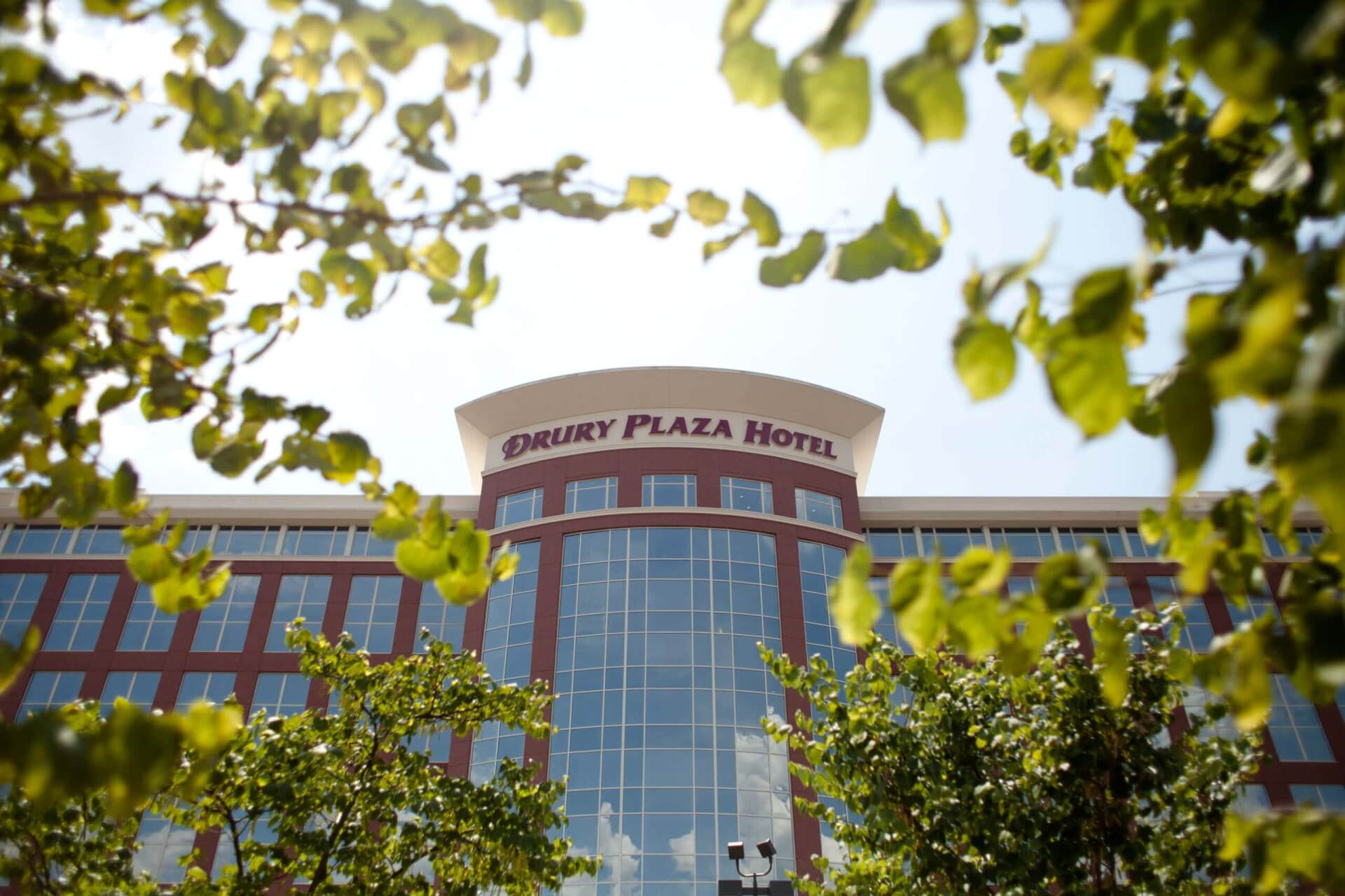 Drury Plaza Hotel Franklin A modern hotel building with a curved glass facade and red brick accents in Williamson County, Tennessee.