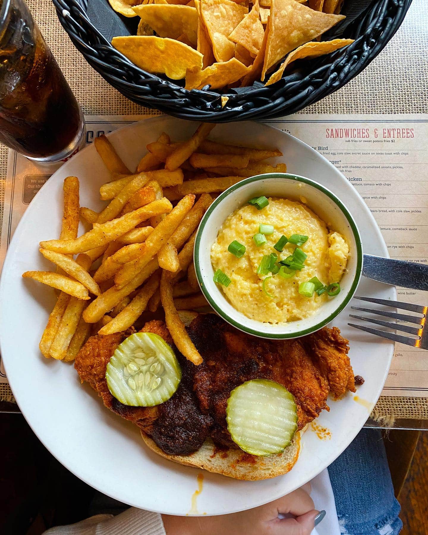 55 South A plate of crispy fried chicken with pickles, mashed potatoes, and french fries in Williamson County, Tennessee.
