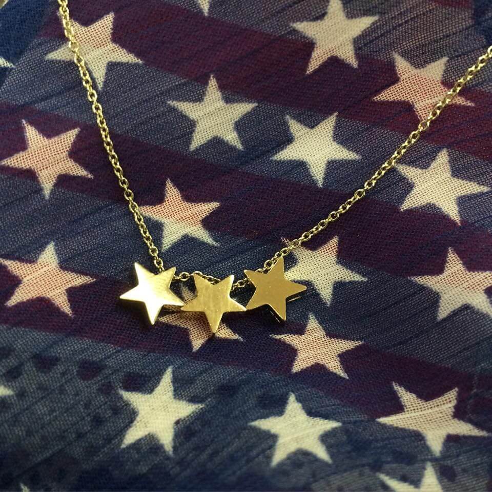 Gold star necklace on American flag fabric with white and red stars in Williamson County, Tennessee.