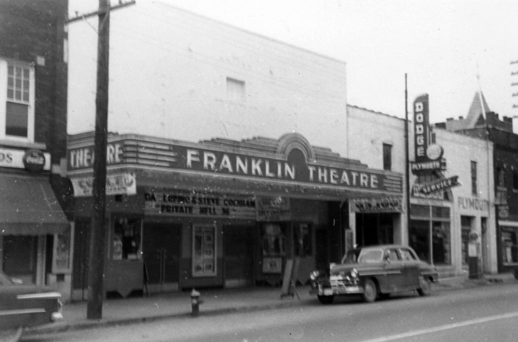 Franklin, Tennessee's Preservation Success Story A vintage black and white photograph of the Franklin Theatre in downtown Plymouth, featuring a classic marquee and a parked car from the 1950s in Williamson County, Tennessee.
