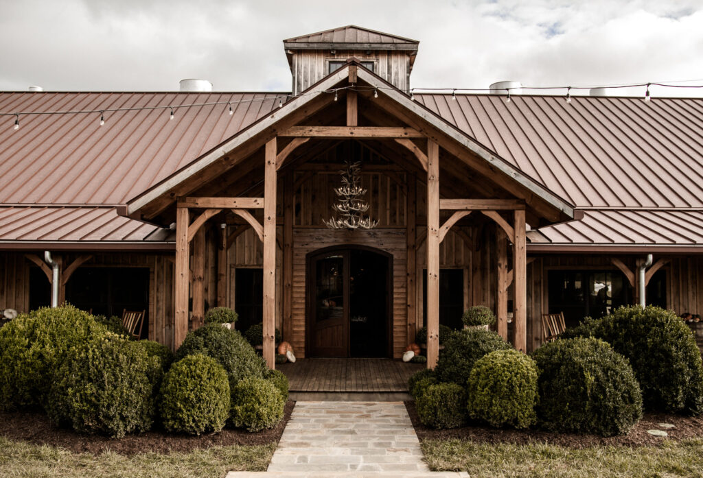 A rustic wooden barn with a metal roof and a stone walkway leading to the entrance in Williamson County, Tennessee.
