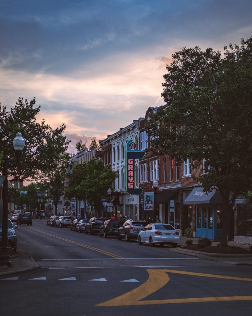 A picturesque small-town street scene at dusk with vintage buildings and parked cars in Williamson County, Tennessee.