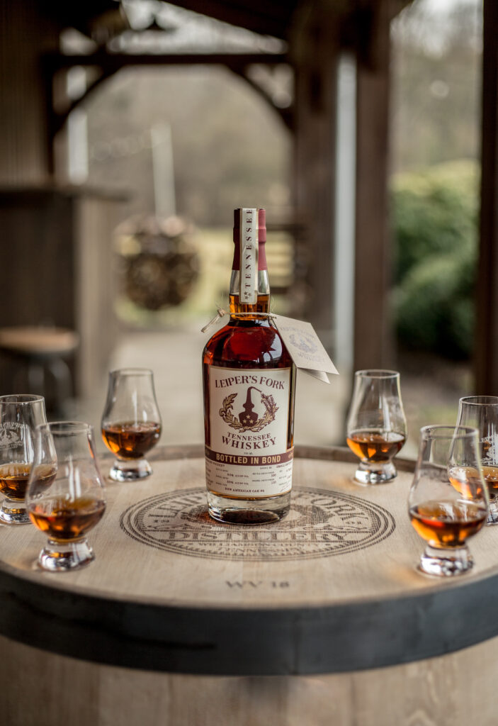 Top 7 Attractions to See in Franklin, Tennessee A bottle of Leiper's Fork Tennessee Whiskey sits on a wooden barrel surrounded by tasting glasses in Williamson County, Tennessee.