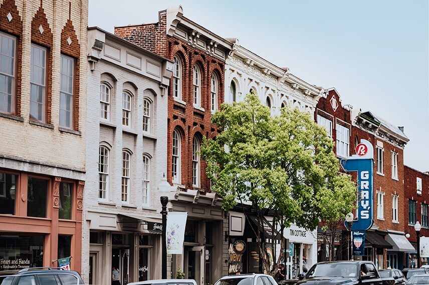 A row of colorful brick buildings with large windows and a tree in front in Williamson County, Tennessee.