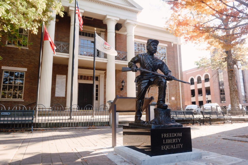 The telling of "The Fuller Story" in Franklin A bronze statue of a soldier with a rifle stands on a pedestal inscribed with 'Freedom, Liberty, Equality' in Williamson County, Tennessee.