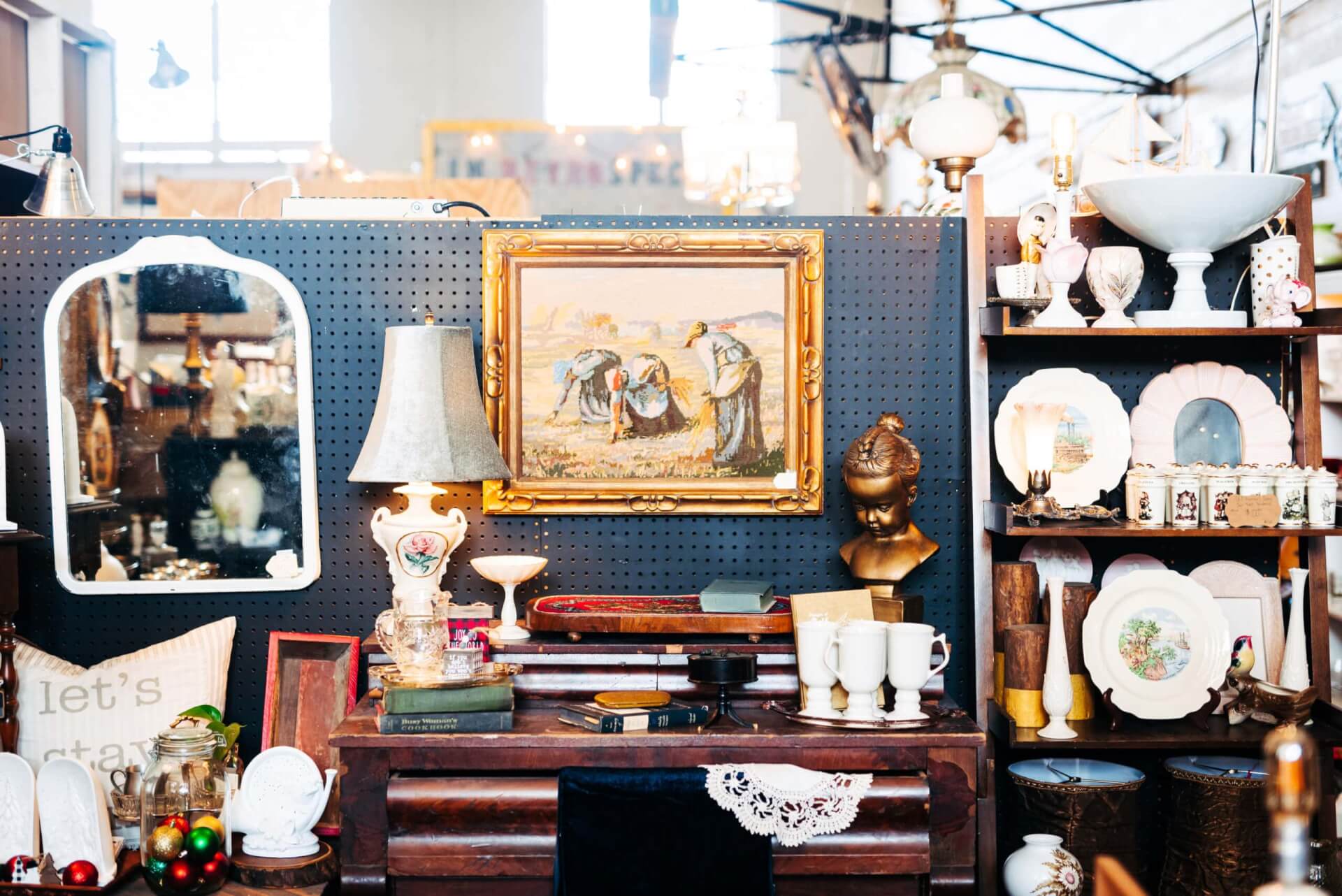 Shopping Vintage shop display with antique furniture, mirrors, paintings, and decorative items in Williamson County, Tennessee.