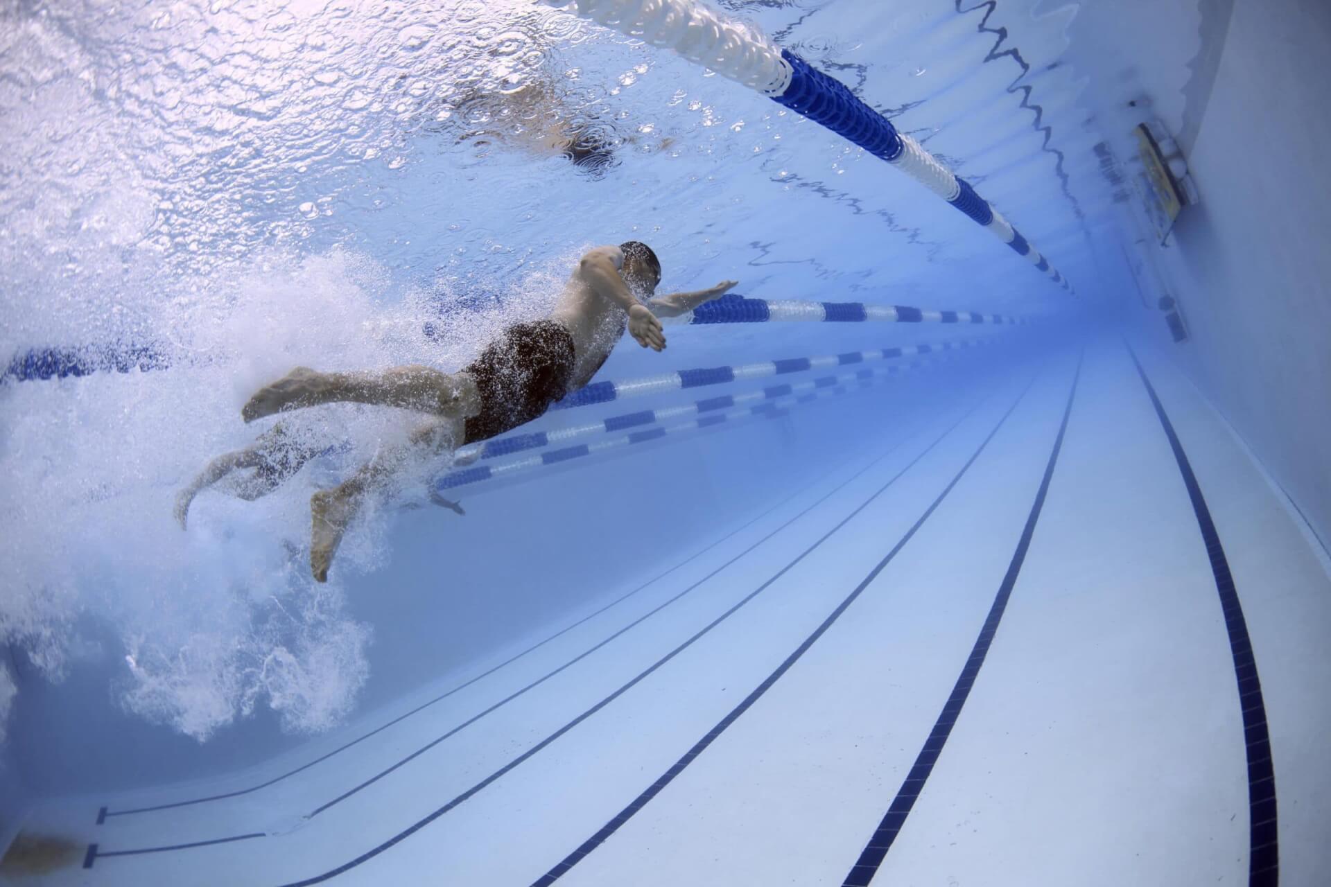 Franklin Recreation Complex A swimmer races underwater in a long, blue pool with lane dividers in Williamson County, Tennessee.