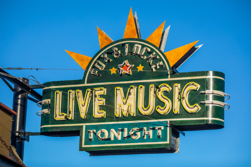 A vibrant neon sign advertising live music tonight at a venue called Fox & Locke in Williamson County, Tennessee.