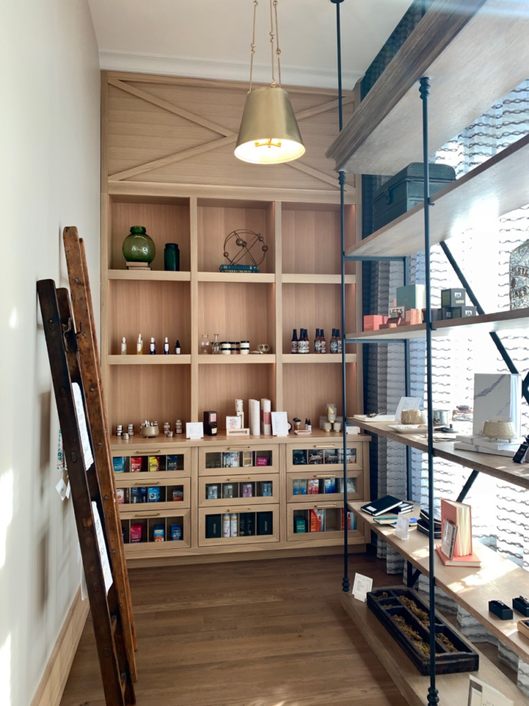 A modern, well-lit room with wooden shelves displaying various items including books, bottles, and decorative objects in Williamson County, Tennessee.