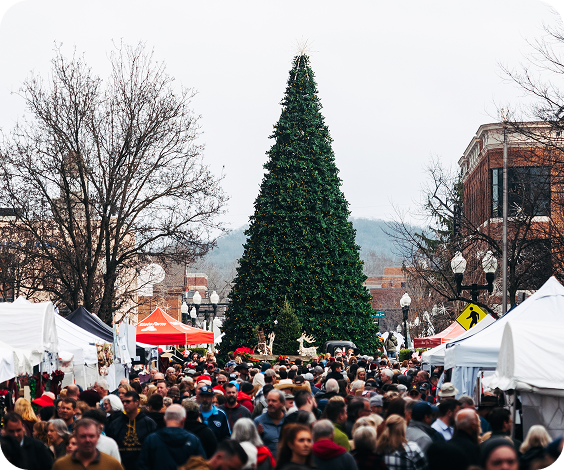 Dickens of a Christmas A bustling outdoor market with a large Christmas tree as the centerpiece in Williamson County, Tennessee.