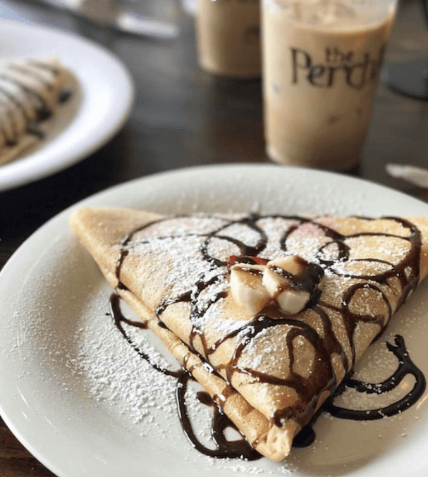 A triangular crepe filled with bananas, drizzled with chocolate sauce, and dusted with powdered sugar in Williamson County, Tennessee.
